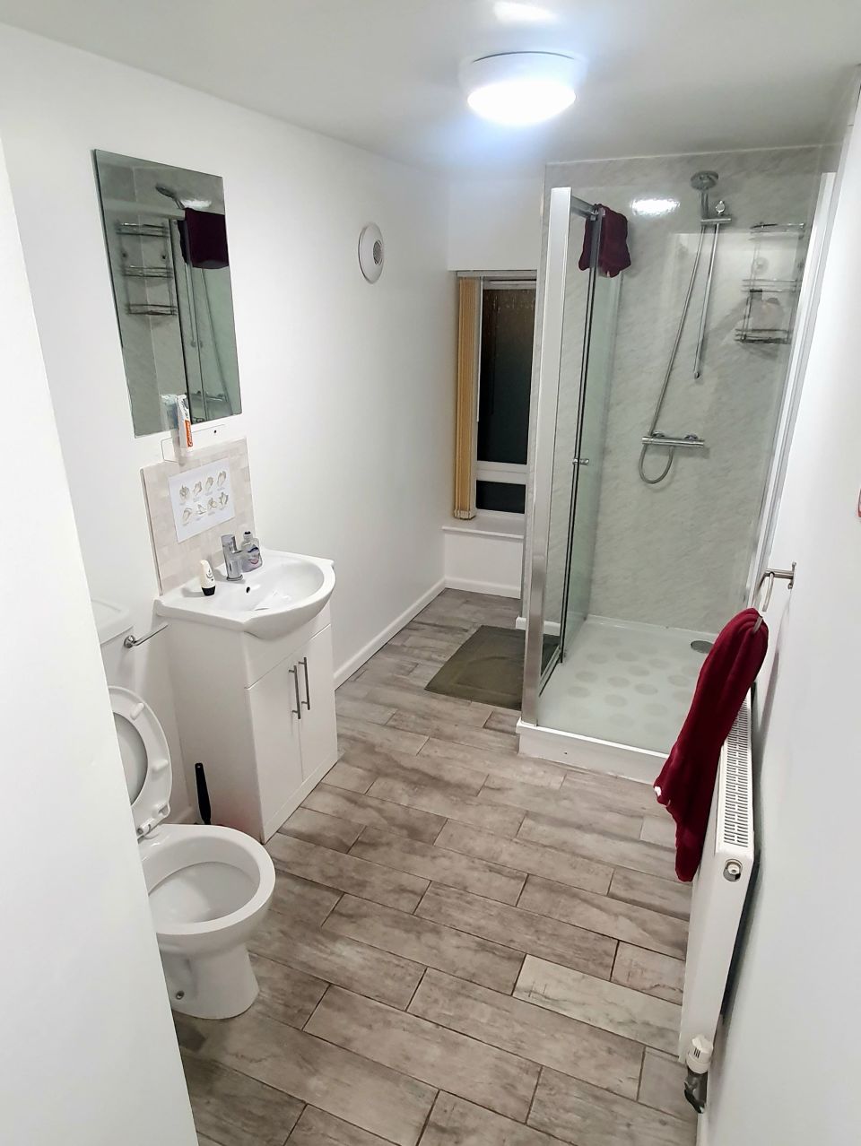 A private en-suite bathroom with shower cubicle, toilet and sink
